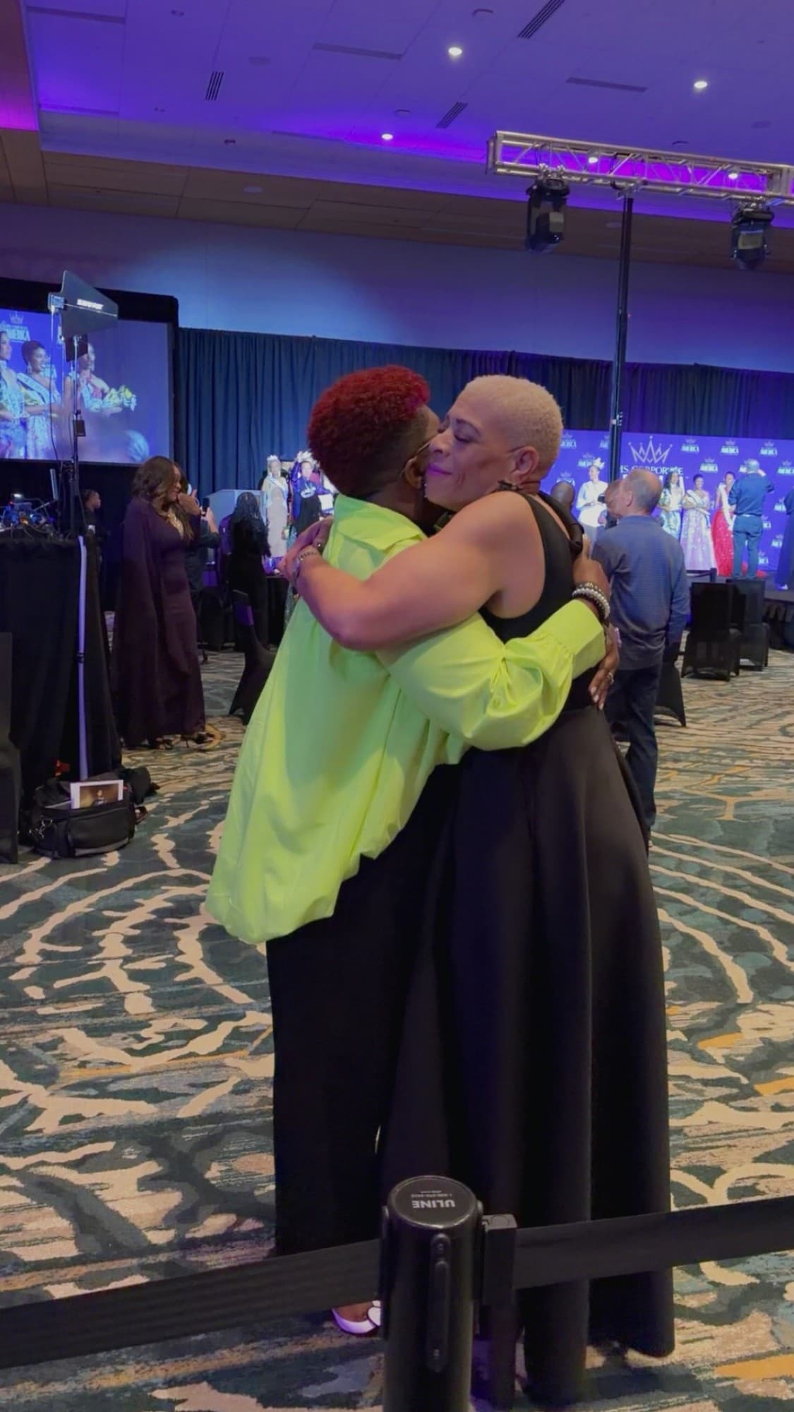 Dr. Sneed embracing a friend at the Ms. Corporate America event