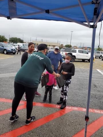 Handing out gifts to children at a community outreach